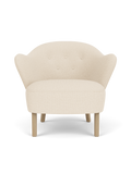 Fauteuil de salon tapissé de textile avec accoudoirs sculpturaux pour le salon