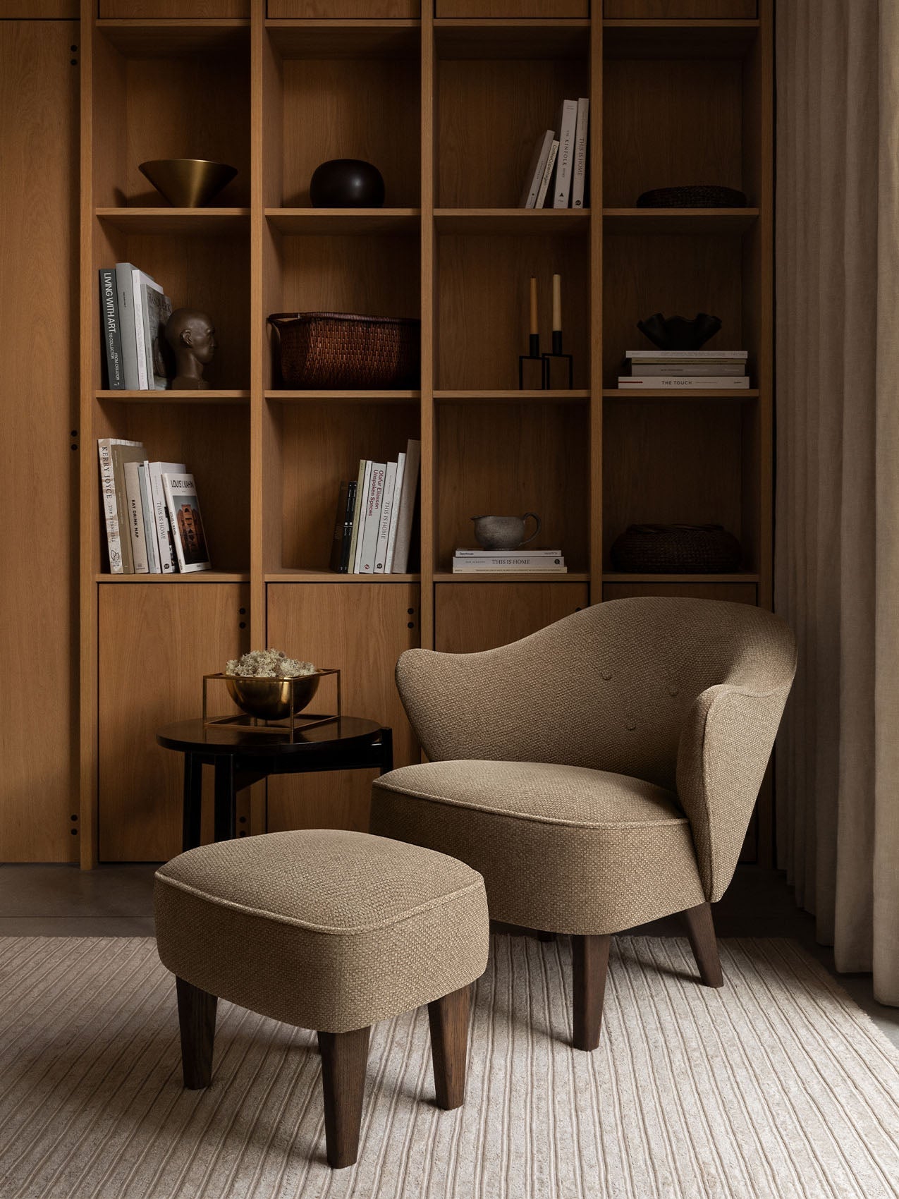 Fauteuil de salon tapissé de textile avec accoudoirs sculpturaux pour le salon